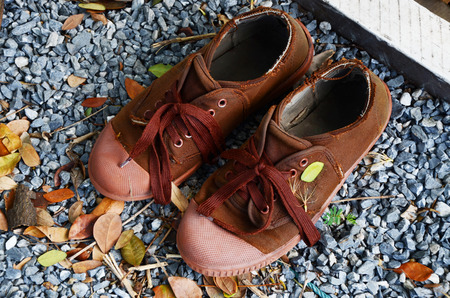 shoes boy scout brown on ground gravelの写真素材