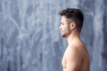 Portrait of handsome man doing yoga and meditation.の写真素材