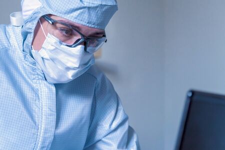 Work with laptop under social distancing and self isolation due to covid-19 virus. Coronovirus outbreak and stay home conceptの写真素材