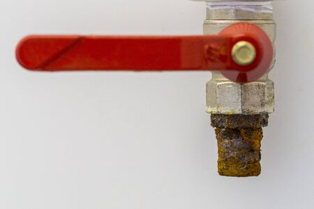 Exterior tap isolated on white wall background.The old faucet with rusty.Save water and environment...
