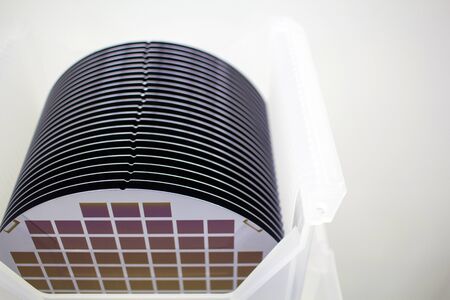 Silicon Wafers in white plastic holder box on table ,background is white color- A wafer is a thin...