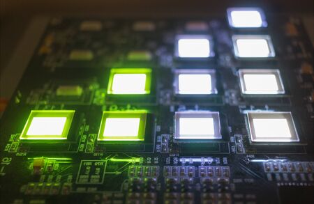 The process of checking several oled displays on the test station. Displays glow brightly of green...