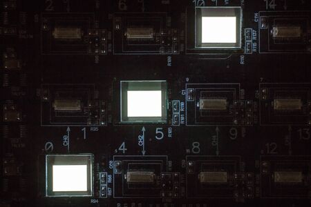 The process of checking several oled displays on the test station. Displays glow brightly of white...