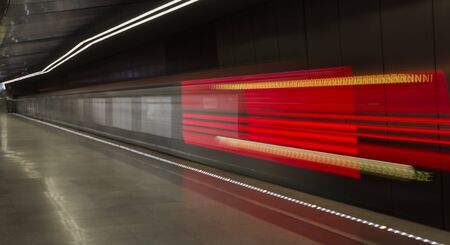 Moving train, motion blurred, Moscow Underground. Russia.Rain station ,red light blurred behinde of trainの写真素材