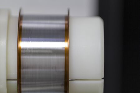 Spool of soldering alloy .Aluminium wire on reel for bonding chip.の写真素材