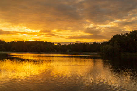 Reflection of the sun in the water at orange sunset. Sunset on a large lake.の写真素材