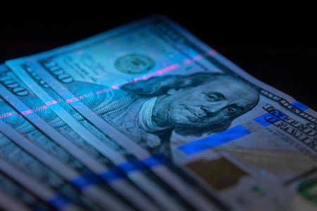 100 dollars banknot currency in UV light protection.Dollars in UV light.Checking money close up