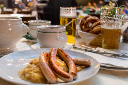 Close up Appetizing German Recipe with Sausage. Classic German dinner of fried sausages with braised...