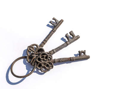 Three old keys on a white backgroundの写真素材