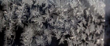 Melting ice running down a window pane,