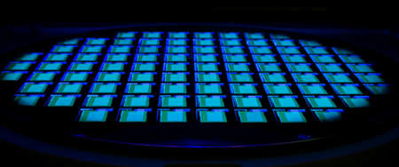 Silicon wafer with chips lightinhg in neon light. Semiconductor.の写真素材
