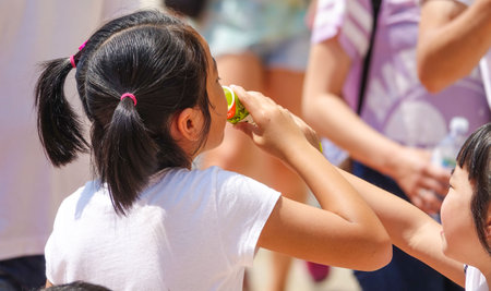 Asian kids eating ice cream in Verona on a hot dayのeditorial素材