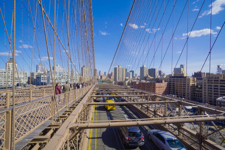 Street traffic on Brooklyn Bridge in New York- MANHATTAN / NEW YORK - APRIL 1, 2017のeditorial素材