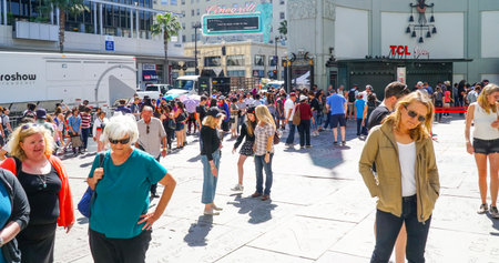 Tourists watching the handprints and footprints on the floor of Chinese Theater in Hollywood - LOS ANGELES - CALIFORNIA - APRIL 20, 2017のeditorial素材