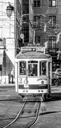 Lisbon - typical street view in the historic district with old tram Electrico - LISBON / PORTUGAL - JUNE 16, 2017のeditorial素材