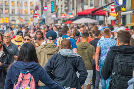 Huge crowd of tourists at famous Damrak street in Amsterdam - AMSTERDAM - THE NETHERLANDS - JULY 20, 2017のeditorial素材