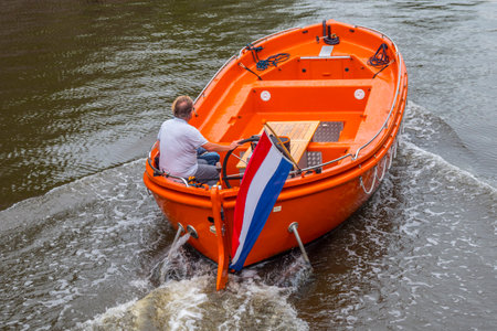 Small boat in the city center of Amsterdam - AMSTERDAM - THE NETHERLANDS - JULY 20, 2017のeditorial素材