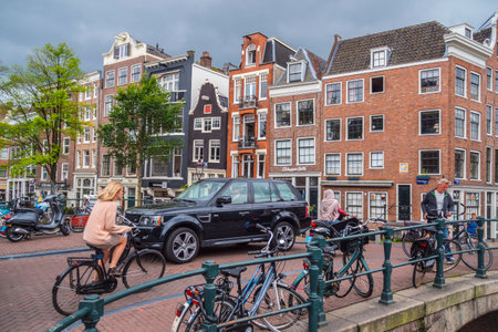 People walking over the beautiful bridges in Amsterdam - AMSTERDAM - THE NETHERLANDS - JULY 20, 2017のeditorial素材