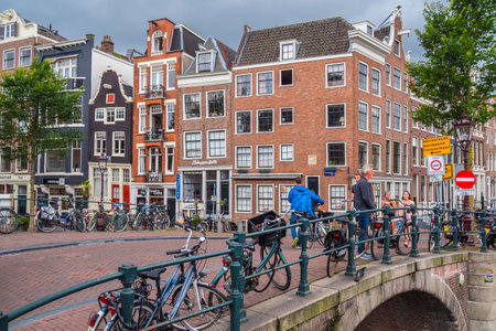 People walking over the beautiful bridges in Amsterdam - AMSTERDAM - THE NETHERLANDS - JULY 20, 2017のeditorial素材