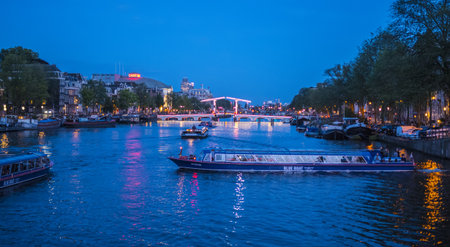 Evening view over famous Amstel River in the city of Amsterdam
