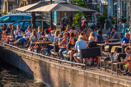Street cafe at the canals of Amsterdam on a sunny dayのeditorial素材