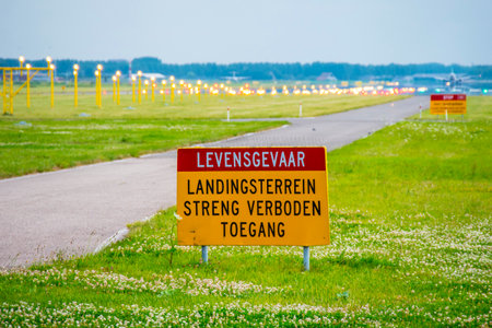 Warning signs at the runway of an airport - AMSTERDAM, HOLLAND - JULY 22, 2017のeditorial素材