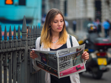Reading a newspaper on the streetのeditorial素材
