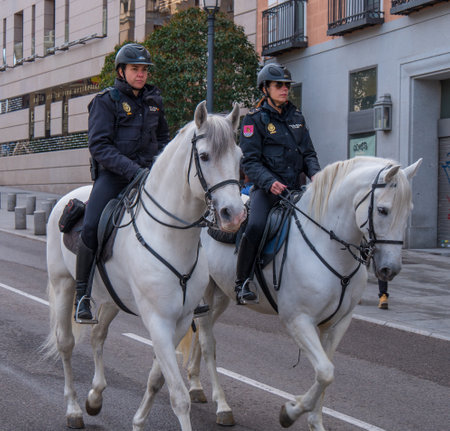 Female Police officers on horses riding through Madrid - MADRID / SPAIN - FEBRUAR 21, 2018のeditorial素材