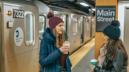 Two women on a platform of a New York subway station wait for their train - NEW YORK, UNITED STATES - DECEMBER 4, 2018のeditorial素材