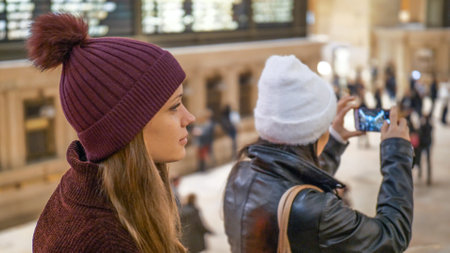 Young women visit Grand Central station New York - NEW YORK, UNITED STATES - DECEMBER 4, 2018のeditorial素材
