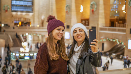 Young women visit Grand Central station New York - NEW YORK, UNITED STATES - DECEMBER 4, 2018のeditorial素材