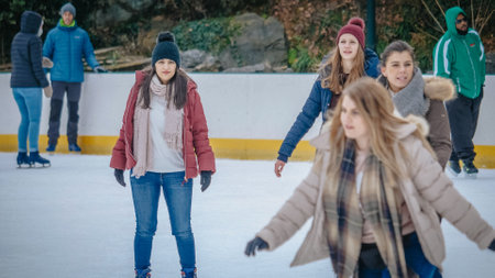 Girls have a lot of fun doing ice skating in New Yorks Central Park - NEW YORK, UNITED STATES - DECEMBER 4, 2018のeditorial素材