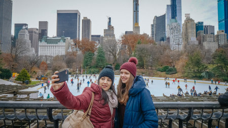 Taking a selfie at the famous Ice Rink in central Park New York - NEW YORK, UNITED STATES - DECEMBER 4, 2018のeditorial素材