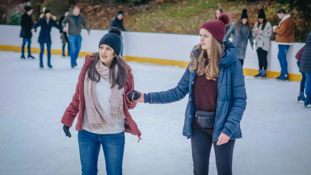 Girls have a lot of fun doing ice skating in New Yorks Central Park - NEW YORK, USA - DECEMBER 4, 2018のeditorial素材