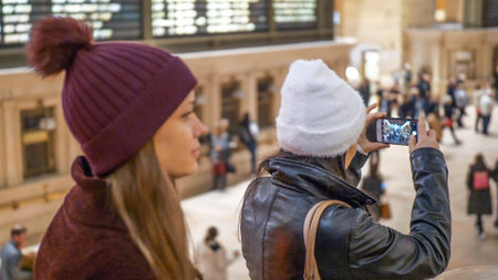 Young women visit Grand Central station New York - NEW YORK, UNITED STATES - DECEMBER 4, 2018のeditorial素材