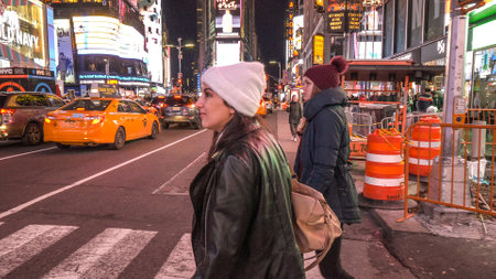Walking at Times Square in Manhattan by night - NEW YORK, UNITED STATES - DECEMBER 4, 2018