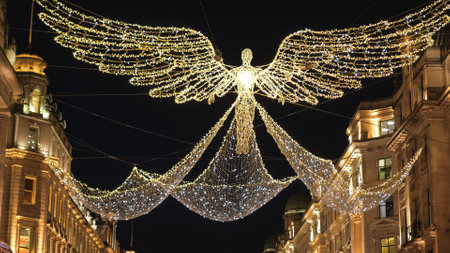 Wonderful Christmas street decoration in London flying angels made of light - LONDON, ENGLAND - DECEMBER 15, 2018のeditorial素材