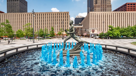 Blue water fountain with Runner Statue at Kiener Plaza Park in St. Louis - ST. LOUIS, USA - JUNE 19, 2019のeditorial素材