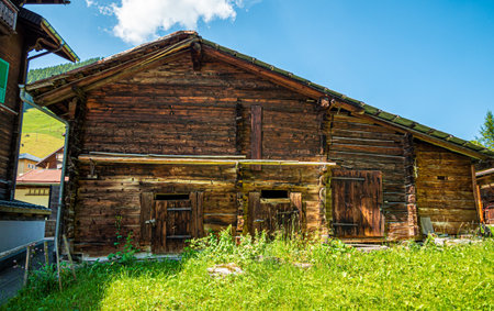 Typical wooden houses of Switzerland in the Swiss Alps - SWISS ALPS, SWITZERLAND - JULY 22, 2019のeditorial素材