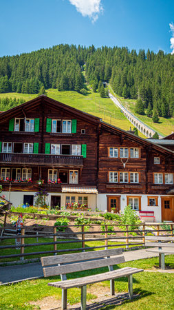 Typical Swiss houses in the village of Murren in the Swiss Alps - SWISS ALPS, SWITZERLAND - JULY 22, 2019のeditorial素材