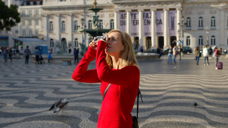 Attractive woman walks over a square at the opera house of Lisbon - CITY OF LISBON, PORTUGAL - OCTOBER 15, 2019のeditorial素材