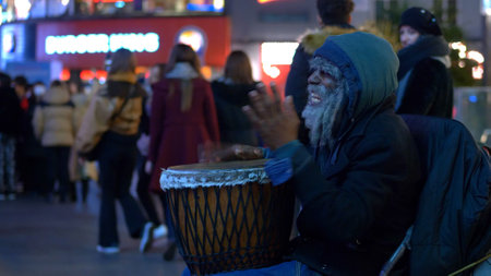 homeless guy raises money as a street musician - LONDON, ENGLAND - DECEMBER 10, 2019のeditorial素材