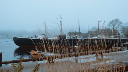 Boats and ships at Mystic seaport in the mist - MYSTIC, USA - APRIL 6, 2017のeditorial素材