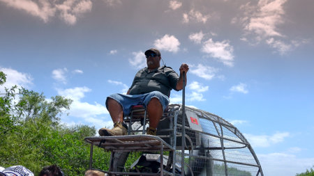 Airboat pilot riding through the Everglades - MIAMI, USA APRIL 11, 2016のeditorial素材