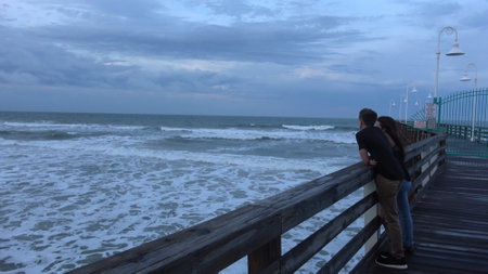 Young couple relaxing on the pier - DAYTONA BEACH, USA APRIL 14, 2016 - travel photographyのeditorial素材