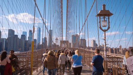 Tourists walking over the Brooklyn Bridge in New York - NEW YORK CITY, USA - APRIL 2, 2017のeditorial素材