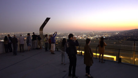 People enjoying the view over Los Angeles from Griffith Observatory - LOS ANGELES, UNITED STATES - APRIL 21, 2017のeditorial素材