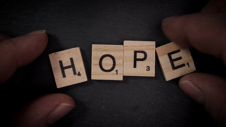 Writing the word Hope with wooden letters - FRANKFURT, GERMANY - MARCH 30, 2021