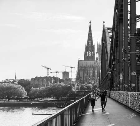 Walking over popular Hohenzollern Bridge in Cologne - CITY OF COLOGNE, GERMANY - JUNE 25, 2021のeditorial素材