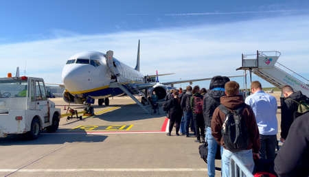 Passengers entering a Ryanair Airplane at Frankfurt Hahn Airport - HAHN, GERMANY - APRIL 20, 2022